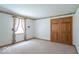 Bedroom with patterned wallpaper border, double closets, and large window at 2979 Colony Lake E Dr, Plainfield, IN 46168