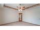 This is a large, carpeted bedroom with a ceiling fan and a doorway with a mirrored door at 2979 Colony Lake E Dr, Plainfield, IN 46168