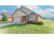 Charming brick home with attached garage, green lawn and bay window, showcasing suburban living at 2979 Colony Lake E Dr, Plainfield, IN 46168