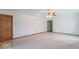 Spacious living room features neutral carpet, closet, and a doorway to other areas of the home at 2979 Colony Lake E Dr, Plainfield, IN 46168
