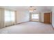 Expansive living room with plush carpeting, bright windows, and a ceiling fan, perfect for relaxation and entertaining at 2979 Colony Lake E Dr, Plainfield, IN 46168