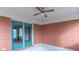 Covered patio with brick walls, neutral carpet, ceiling fan and sliding blue glass doors at 2979 Colony Lake E Dr, Plainfield, IN 46168