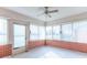Enclosed sun room featuring neutral carpet, brick walls, and large windows with blinds and a ceiling fan at 2979 Colony Lake E Dr, Plainfield, IN 46168