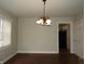 Classic dining room boasts hardwood floors and a decorative chandelier at 3160 Graceland Ave, Indianapolis, IN 46208
