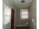 An entryway with a brown door, hardwood floors, window with blinds, and painted walls at 3160 Graceland Ave, Indianapolis, IN 46208