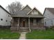 Charming home featuring a covered front porch and neutral siding and trim at 3160 Graceland Ave, Indianapolis, IN 46208