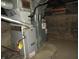 A furnace, water heater and ductwork in a utility room with stone walls and a concrete floor at 3160 Graceland Ave, Indianapolis, IN 46208