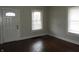 Bright living room featuring hardwood floors, and natural light from two windows at 3160 Graceland Ave, Indianapolis, IN 46208