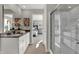 Elegant primary bath with double sink, mirror, shower and view to main bedroom at 3302 Wetherby Pl, Danville, IN 46122