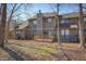 An expansive backyard featuring a wooden deck and mature trees casting shadows on the lawn at 4247 Larkspur Trce, Indianapolis, IN 46237