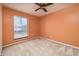 Bright bedroom with neutral-toned walls, a window overlooking the neighborhood, and plush carpeting at 4247 Larkspur Trce, Indianapolis, IN 46237