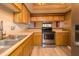Bright kitchen featuring wood cabinets, light countertops, and a stainless steel range at 4247 Larkspur Trce, Indianapolis, IN 46237
