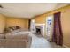 Inviting living room with neutral carpeting, stone fireplace, and sliding glass doors at 4247 Larkspur Trce, Indianapolis, IN 46237