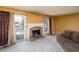 Inviting living room with neutral carpeting, stone fireplace, and sliding glass doors at 4247 Larkspur Trce, Indianapolis, IN 46237