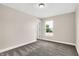 Neutral bedroom features a cozy carpet, window, and a white door at 449 Hidden Hills Dr, Pittsboro, IN 46167