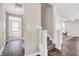 Bright hallway features wood floors and carpeted stairs at 449 Hidden Hills Dr, Pittsboro, IN 46167