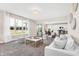 Open-concept living space with bright light, neutral decor, seamless flow to dining, and contemporary furniture at 449 Hidden Hills Dr, Pittsboro, IN 46167