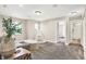 Bright living room with neutral walls, plush carpet, and views into other rooms at 449 Hidden Hills Dr, Pittsboro, IN 46167