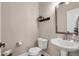Modern powder room with a pedestal sink, framed mirror, modern fixtures, and neutral paint at 449 Hidden Hills Dr, Pittsboro, IN 46167