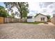 Expansive backyard featuring a shed, gravel parking area, and firepit at 509 St Paul St, Indianapolis, IN 46203