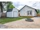 Cozy backyard featuring a shed, fire pit, and lovely white cottage style home at 509 St Paul St, Indianapolis, IN 46203