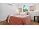 Inviting bedroom features a bright window and a patterned red and white blanket at 509 St Paul St, Indianapolis, IN 46203