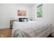 Bright bedroom with a large window, art, and striped bedding at 509 St Paul St, Indianapolis, IN 46203