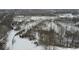 An aerial view shows the backyard's wooded boundary covered in snow, giving it privacy and a sense of seclusion at 5791 Station Hill Dr, Avon, IN 46123