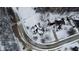 An aerial view shows a home with a dark roof and white siding surrounded by a snow-covered lawn and trees at 5791 Station Hill Dr, Avon, IN 46123