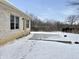 Backyard featuring a concrete patio, brick exterior and snow-covered lawn at 5791 Station Hill Dr, Avon, IN 46123