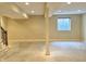 Unfinished basement with a window, support beam, recessed lighting, and stairway at 5791 Station Hill Dr, Avon, IN 46123