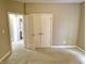 This bedroom features neutral walls, carpet flooring, and a double-door closet for ample storage at 5791 Station Hill Dr, Avon, IN 46123