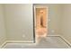 Unfinished bedroom shows neutral walls, baseboards, and an open doorway leading to an additional room at 5791 Station Hill Dr, Avon, IN 46123
