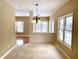 Sun-filled dining room boasts a modern chandelier and multiple windows at 5791 Station Hill Dr, Avon, IN 46123