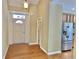 The house entryway features hardwood floors and a white front door next to an open doorway and stainless fridge at 5791 Station Hill Dr, Avon, IN 46123