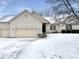 Charming single Gathering home with a brick exterior, attached garages and snow covered front yard at 5791 Station Hill Dr, Avon, IN 46123