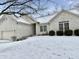 Charming single Gathering home with a brick exterior, attached garage and snow covered front yard at 5791 Station Hill Dr, Avon, IN 46123