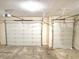 Garage features two overhead doors, concrete flooring, and a ceiling mounted garage door opener at 5791 Station Hill Dr, Avon, IN 46123