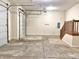 Garage area with concrete flooring and stairs leading to an upper level, as well as a garage door opener at 5791 Station Hill Dr, Avon, IN 46123