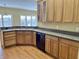 A spacious kitchen with wood cabinets, dark countertops, and a black dishwasher at 5791 Station Hill Dr, Avon, IN 46123