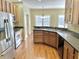 An eat-in kitchen showcases wood cabinets, stainless appliances, and great natural light at 5791 Station Hill Dr, Avon, IN 46123