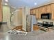 Features wood cabinets, stainless steel appliances, and a gray countertop at 5791 Station Hill Dr, Avon, IN 46123