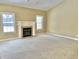 Living room featuring a fireplace with white mantle and large windows providing natural light at 5791 Station Hill Dr, Avon, IN 46123