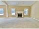 Bright living room featuring a fireplace with white mantle and large windows providing natural light at 5791 Station Hill Dr, Avon, IN 46123