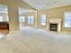 Living room featuring a fireplace with white mantle and large windows providing natural light at 5791 Station Hill Dr, Avon, IN 46123