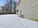 Side exterior of the house featuring a snow-covered lawn and brick exterior at 5791 Station Hill Dr, Avon, IN 46123