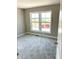 Bedroom with a large window overlooking the side yard at 640 Firefly Ct, Greenfield, IN 46140