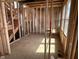 Living room showcasing framing, windows, and a future staircase at 640 Firefly Ct, Greenfield, IN 46140