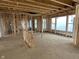 Living room featuring wall framework, with window and open-concept layout at 640 Firefly Ct, Greenfield, IN 46140