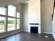 Open concept living room with fireplace and large windows overlooking the backyard at 640 Firefly Ct, Greenfield, IN 46140
